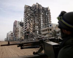 An Israeli soldier sits in a Humvee amid the ongoing ground operation of the Israeli army against...