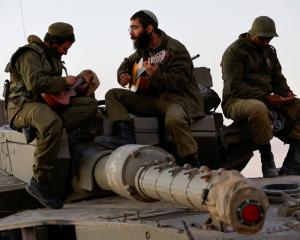 Israeli troops relax during the Gaza truce. PHOTO: REUTERS