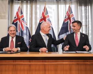 Party leaders (from left) Winston Peters, Christopher Luxon, and David Seymour sign coalition...