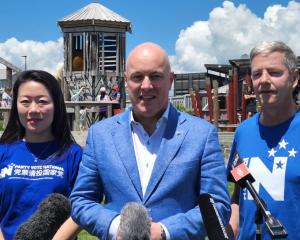 Incoming Prime Minister Christopher Luxon (centre), with Nancy Lu (left) and MP Andrew Bayly ...