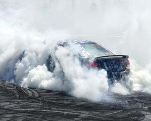 Katlyn Stoddart, of Tapanui, smokes it up in her Ford Falcon during the Lawrence Burnouts at the...