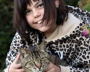 Stella Young, 9, is delighted to be reunited with her cat Neo after he was trapped in the roof...