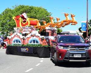 Santa Claus sits atop his sleigh with reindeer leading the way in Dee St, during the Invercargill...