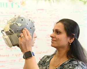 University of Otago senior research fellow Dr Divya Adhia examines a model of a head wearing a...
