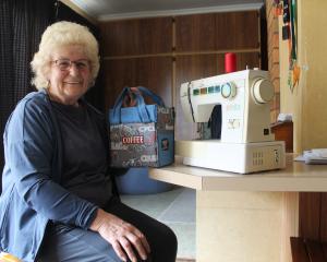 Lorna Argyle with a bicycle-themed coffee takeaway bag she created on her sewing machine. PHOTO:...