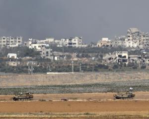 Israeli military vehicles manoeuvre near the border with Gaza in Israel, amid the ongoing...