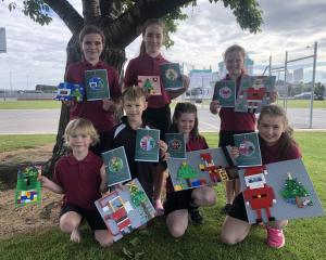 Showing off the Lego models they made which were photographed and made into Christmas greeting...