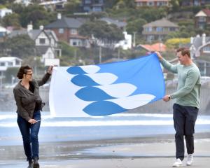 St Clair Esplanade Hydro building trustee Katherine Greer with Jeremiah Hall and his winning flag...