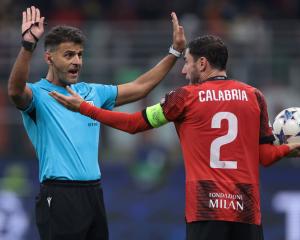 Referee Jesus Gil Manzano warns Davide Calabria of AC Milan to end his time wasting antics during...