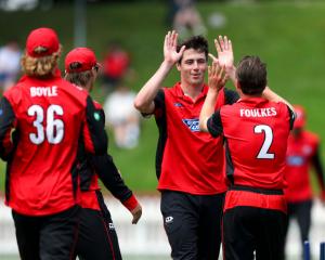 Will O’Rourke (second right) celebrates with his Canterbury team-mates after taking a wicket in...