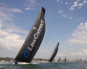LawConnect heads up Sydney Harbour at the start of the 2023 Sydney to Hobart race. Photo: Getty...