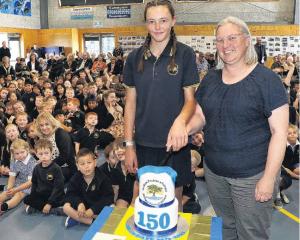 Kaiapoi Borough School pupil Makayla Krahagen, 13, cuts the 150th celebration cake with Board of...