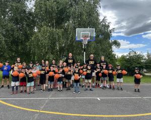 Glenorchy Primary School pupils, former NBL player Benjamin Knight and school staff with the...