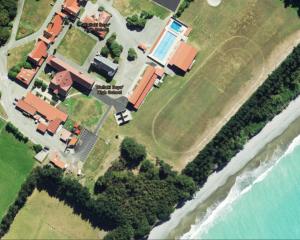 An aerial view from this year shows coastal erosion encroaching towards Waitaki Boys’ High School...