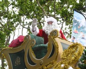 Santa waves to the crowd from his sleigh at the 2023 Dunedin Santa Parade yesterday. PHOTOS:...