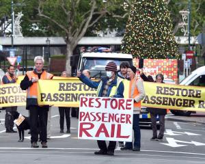 Restore Passenger Rail protesters march down Stuart St towards Dunedin Railway Station. PHOTO:...