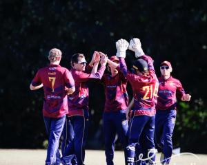 Matt Hay (2nd left) celebrates a wicket with his Burnside West Uni teammates. PHOTO: ELIZABETH...