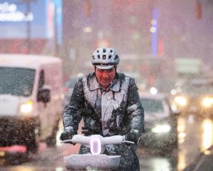 A hardy cyclist braves the morning snow near Times Square in New York. Photo: Reuters 


