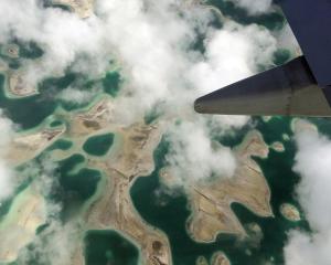 Lagoons can be seen from a plane as it flies above Kiritimati Island, part of the nation of...