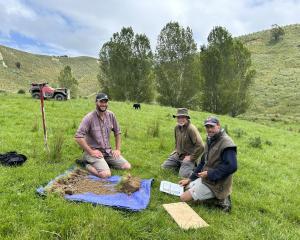 Quorum Sense project leader Sam Lang (left) assesses the soil in a trial paddock with Michael...