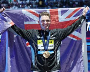 New Zealander Lewis Clareburt celebrates after his win in the 400m individual medley at the World...