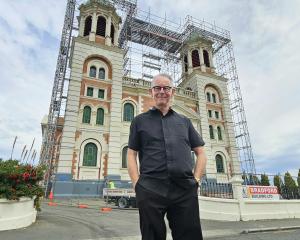 Holy Family Timaru Catholic parish priest Fr Chris Friel admires the work being done to re-copper...
