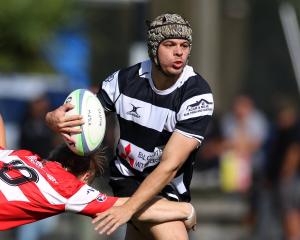 Crescent second five Ethan Edwards tries to escape the clutches of Clutha first five Samuel...