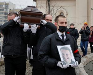 Ceremonial services' employees carry to coffin of Russian opposition politician Alexei Navalny...