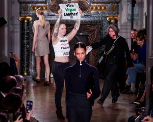 An animal rights protester got on the stage during designer Victoria Beckham's Fall-Winter 2024...