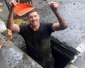 Dunedin man Andrew James stands in a North Dunedin drain holding his friend’s wedding ring....