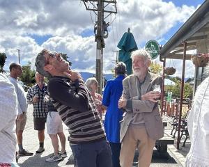 Former professional road cycling champion Julian Dean (left) enjoys a story told by his...