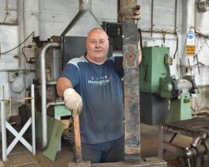 Brown &amp; Cope owner Wayne Sheridan forges a leaf plate from the suspension system of an...