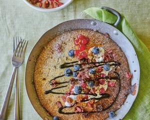 Seeded baked pancake with berries and cocoa sauce.