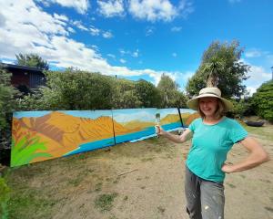 Wānaka mural artist Chrissy Wicks with a mural she is completing for Wānaka Plunket rooms. PHOTO:...