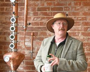 Dunedin historian Gregor Campbell showcases a bottle of Dunedin dry gin, at Dunedin Craft...