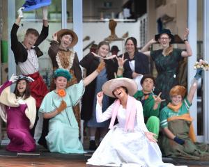 Taieri College pupil Made Newson (front) poses in a wedding dress outside op shop Shop on Carroll...