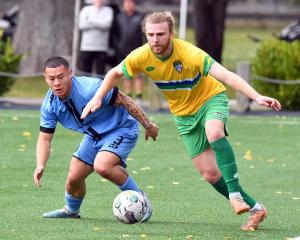 Dunedin City Royals defender Braden Fowell (left) tracks Cashmere Technical forward Jack Hallahan...