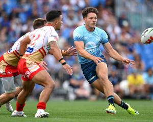 Luke Metcalf of the Warriors passes during an NRL preseason match against the Dolphins at Mt...