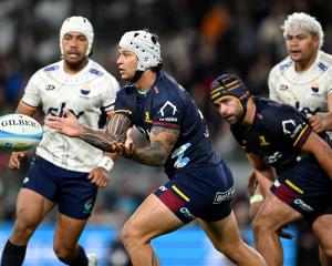 Jonah Lowe has Highlanders captain Billy Harmon in support as he sends the ball outduring the...