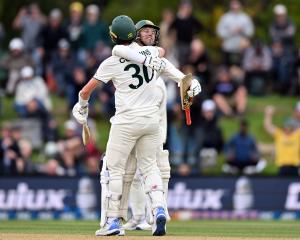 Skipper Pat Cummins and Alex Carey celebrate winning the second test in Christchurch. Photo:...