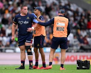 Highlanders prop Ethan de Groot gets some medical attention before leaving the field during the...