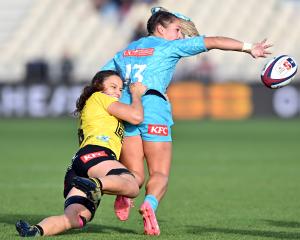 Amy du Plessis of Matatu offloads the ball during her side’s round five Super Rugby Aupiki match...