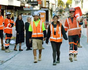 Construction workers (front from left) Talia Walsh, Hayley Poni and Marty McDonnell strut down...