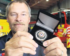 Swannanoa Volunteer Fire Brigade chief fire officer Peter Anderson holds one of the 75...