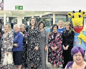 Harold the giraffe, Marion Dent (fifth from left) and Moyra Whiting (second from right) with...