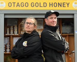 Otago Gold Honey owners Carlee McCaw and Tom Sinclair stand in front of their honey stall...