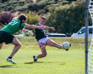 St Pat’s Emerald City Gaelic football player, Ger Sheehan, tries to shut down Adrian O’Dea, of...