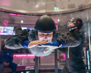 Prime Minister Christopher Luxon tries his hand at indoor skydiving during a visit to iFly in...