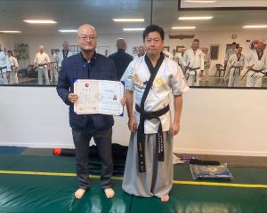 Senior instructors from Timaru Olympic taekwondo master William Kim (left) and master Jason Kim...
