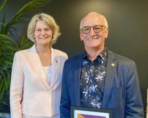 Business Mentors New Zealand chief executive Sarah Trotman congratulates mentor Mike Henderson,...
